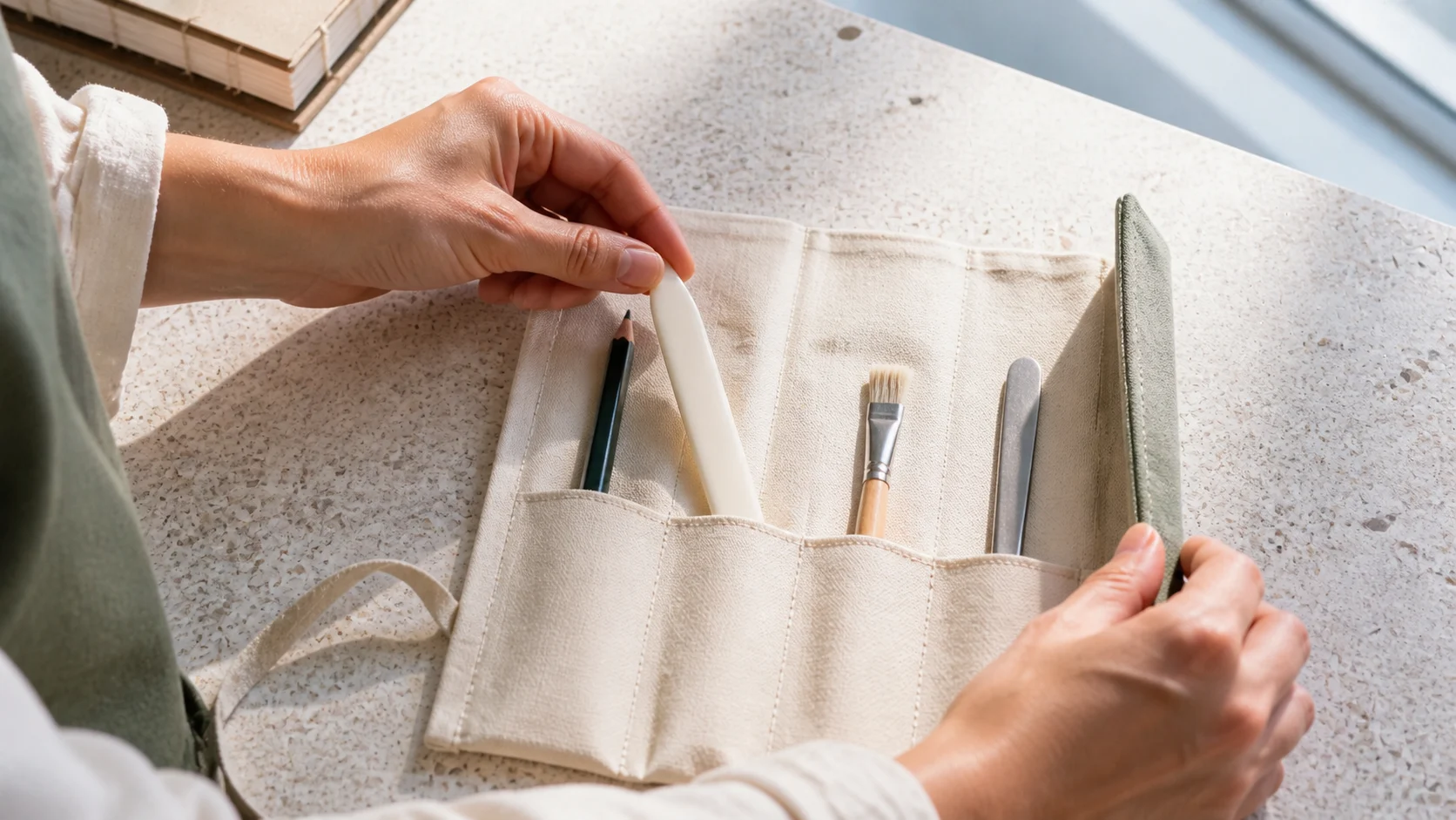 A hand chooses one tool from a compact four-part workflow kit.